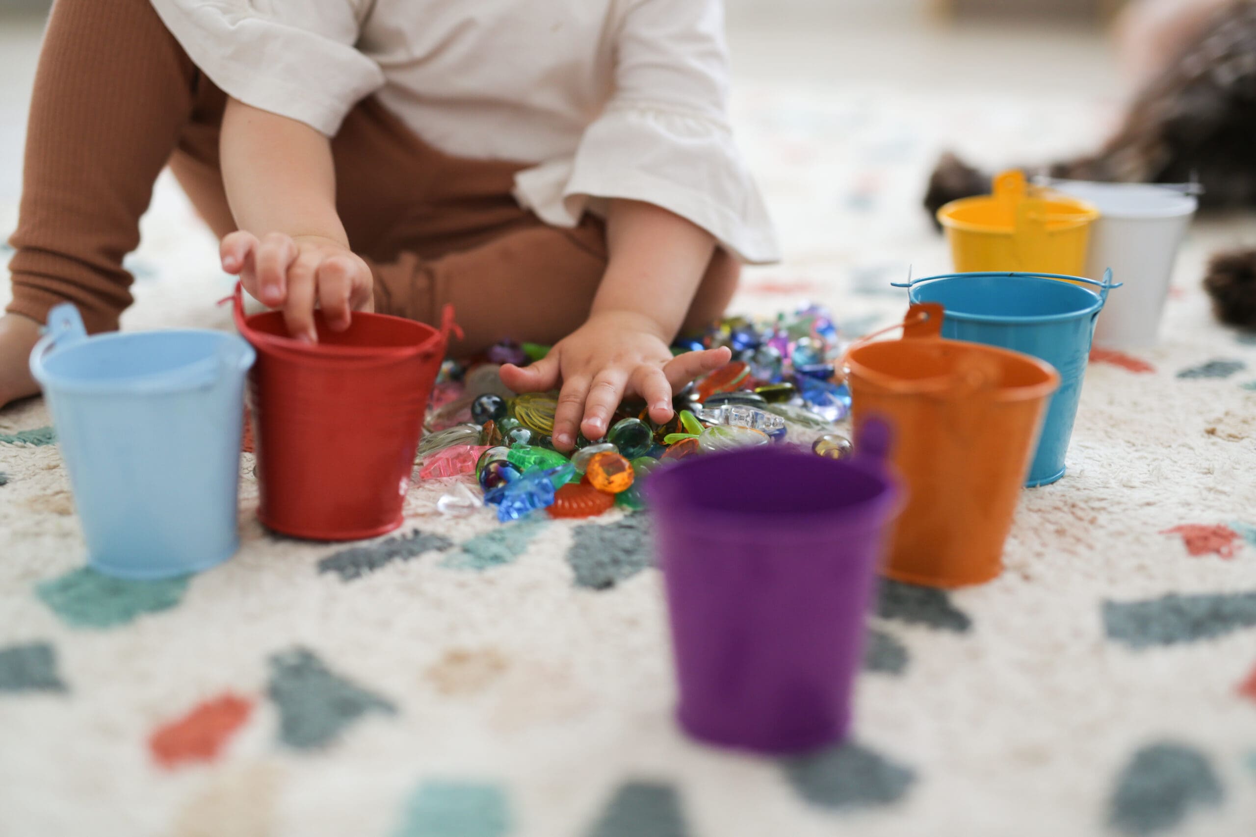 Toddler,Girl,Plays,With,Beads,And,Multicolored,Buckets,,The,Development