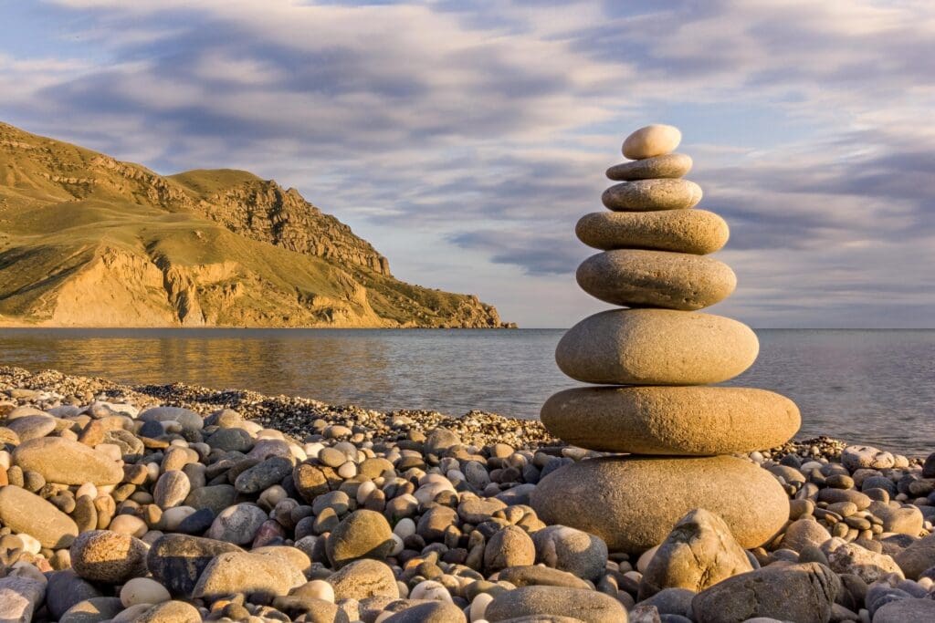 Pebble,Stack,On,The,Sea,Coast,Line,And,Mountains