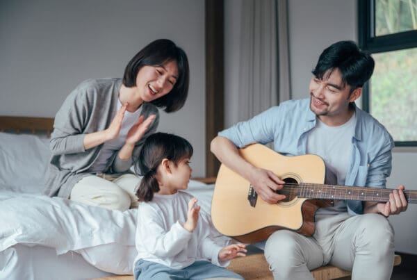 Mom,And,Dad,And,Daughter,Sing,At,Home