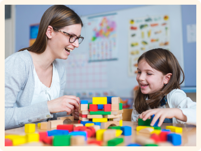 therapist playing blocks with girl