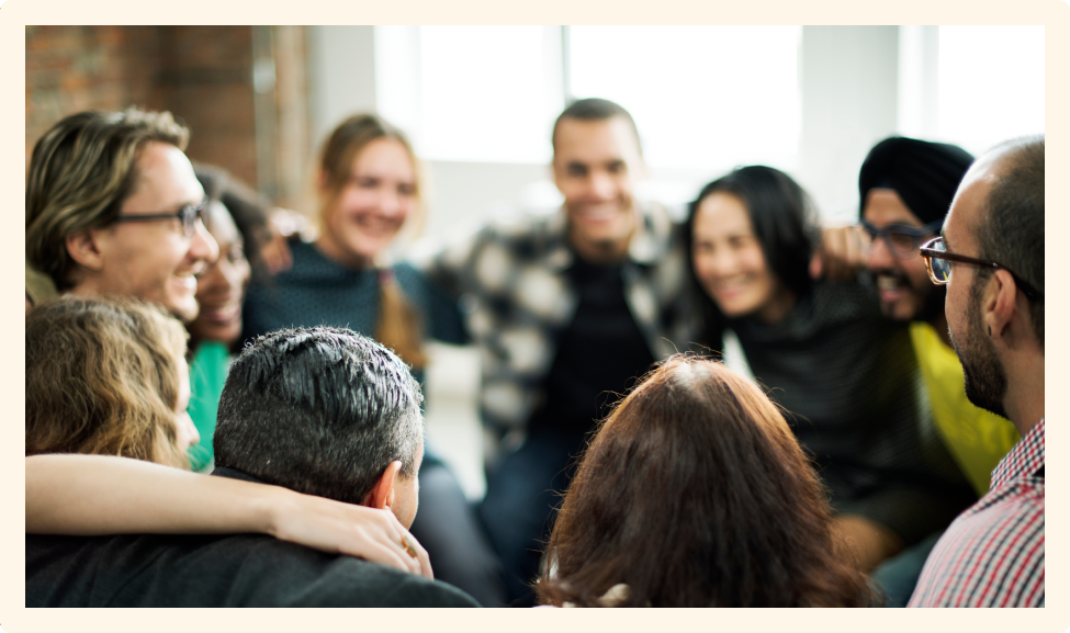 Happy people huddling in a room